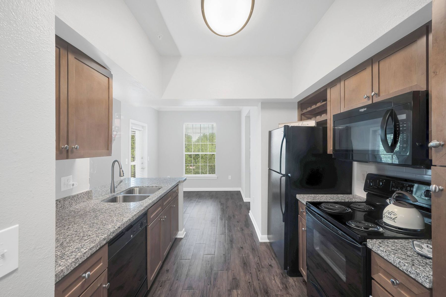 Luxury apartment kitchen with stainless steel appliances, granite countertops, and lots of storage space